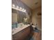 Bathroom with a vanity, ample lighting, and well-appointed accessories at 10548 Ettenmoor Ave, Las Vegas, NV 89135