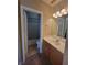 Well-lit bathroom featuring a single sink vanity, and a shower/tub with a blue patterned curtain at 10548 Ettenmoor Ave, Las Vegas, NV 89135