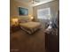 Comfortable bedroom with neutral tones, natural light, and a cozy ambiance at 10548 Ettenmoor Ave, Las Vegas, NV 89135