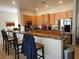 Well-equipped kitchen featuring granite countertops, stainless steel appliances and breakfast bar seating at 10548 Ettenmoor Ave, Las Vegas, NV 89135