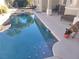 Backyard oasis featuring a sparkling pool with stone accents, and outdoor seating at 10548 Ettenmoor Ave, Las Vegas, NV 89135