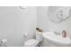 Charming powder room featuring a pedestal sink, decorative mirror, and modern fixtures at 1125 Meadow Sparrow Pl, Henderson, NV 89011