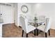 Dining area featuring a glass table, upholstered chairs, and stylish decor at 1125 Meadow Sparrow Pl, Henderson, NV 89011