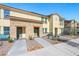 Townhome exterior showcases tidy landscaping, sidewalk, and two-story design at 1125 Meadow Sparrow Pl, Henderson, NV 89011