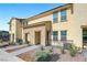 Two-story townhome featuring stone accents, tidy landscaping, and sidewalk appeal at 1125 Meadow Sparrow Pl, Henderson, NV 89011