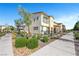 Two-story townhome featuring sidewalks, tidy landscaping, and clear skies at 1125 Meadow Sparrow Pl, Henderson, NV 89011