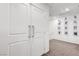 Hallway with large white doors and modern silver hardware at 1125 Meadow Sparrow Pl, Henderson, NV 89011