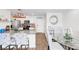 Bright kitchen boasts a granite countertop island with decorative chairs and adjacent dining area at 1125 Meadow Sparrow Pl, Henderson, NV 89011