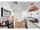 Bright, open kitchen featuring stainless appliances, tile backsplash and granite countertops at 1125 Meadow Sparrow Pl, Henderson, NV 89011