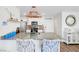 A well-lit kitchen showcasing granite countertops, white cabinets, and modern copper accents at 1125 Meadow Sparrow Pl, Henderson, NV 89011