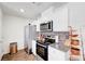 Modern kitchen equipped with stainless steel appliances, white cabinets, and granite countertops at 1125 Meadow Sparrow Pl, Henderson, NV 89011