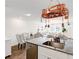 Open concept space features kitchen with island connected to living and dining areas at 1125 Meadow Sparrow Pl, Henderson, NV 89011