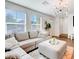 Cozy living room with an inviting sectional sofa and modern chandelier lighting at 1125 Meadow Sparrow Pl, Henderson, NV 89011