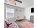 Comfortable main bedroom with natural light, ceiling fan and a fluffy pink rug at 1125 Meadow Sparrow Pl, Henderson, NV 89011