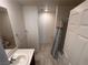 Bathroom with single sink vanity and shower featuring neutral tones and practical design at 1145 Belton Lake Ave, North Las Vegas, NV 89086