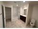 Well-lit bathroom featuring a double sink vanity, bathtub with shower, and tiled flooring at 1145 Belton Lake Ave, North Las Vegas, NV 89086