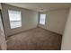 Bright carpeted bedroom featuring two windows and ample space, providing comfort and functionality at 1145 Belton Lake Ave, North Las Vegas, NV 89086