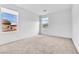Bright bedroom with dual windows offering outside views and neutral carpeting at 1145 Belton Lake Ave, North Las Vegas, NV 89086