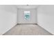 Neutral bedroom with a window offering outside views and wall to wall carpeting at 1145 Belton Lake Ave, North Las Vegas, NV 89086