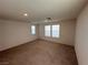 Spacious bedroom with carpet flooring and natural light from windows, perfect for relaxation at 1145 Belton Lake Ave, North Las Vegas, NV 89086