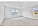 Spacious, carpeted main bedroom features white walls and bright windows at 1145 Belton Lake Ave, North Las Vegas, NV 89086