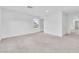 Light-filled main bedroom with neutral carpeting, white walls, and a bright window at 1145 Belton Lake Ave, North Las Vegas, NV 89086