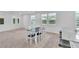 Open-concept dining area with natural light, a modern table set, and seamless flow into the kitchen at 1145 Belton Lake Ave, North Las Vegas, NV 89086