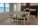 Bright dining room with a dining table set and ample natural light streaming through the windows at 1145 Belton Lake Ave, North Las Vegas, NV 89086
