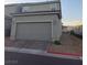 Attached two-car garage featuring brick driveway and desert landscaping at 1145 Belton Lake Ave, North Las Vegas, NV 89086