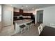 The open kitchen has an island with barstool seating, granite countertops, and modern appliances at 1145 Belton Lake Ave, North Las Vegas, NV 89086