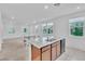 Bright kitchen featuring an island with granite countertops, stainless steel appliances, and an adjacent dining area at 1145 Belton Lake Ave, North Las Vegas, NV 89086