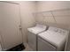 Functional laundry room equipped with a washer, dryer, and overhead shelving for convenience at 1145 Belton Lake Ave, North Las Vegas, NV 89086