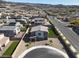 Drone image of a Gathering home with artificial grass, fenced backyard, and easy neighborhood access at 1297 Ventura Cliffs Ave, Henderson, NV 89012