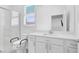Clean, all-white bathroom with a glass shower, toilet, and vanity with a sink at 1297 Ventura Cliffs Ave, Henderson, NV 89012