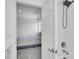 Bathroom with tiled shower, chrome fixtures, and view into the adjoining bedroom at 1297 Ventura Cliffs Ave, Henderson, NV 89012