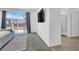 Bright bedroom boasts balcony access, large TV and modern bathroom entry at 1297 Ventura Cliffs Ave, Henderson, NV 89012