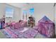 Charming bedroom with princess theme, including a dollhouse, and themed decor at 1297 Ventura Cliffs Ave, Henderson, NV 89012