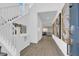Inviting home entryway with bright white accents, wood floors and modern decor at 1297 Ventura Cliffs Ave, Henderson, NV 89012