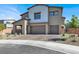 Charming two-story home showcasing desert landscaping and a spacious three-car garage at 1297 Ventura Cliffs Ave, Henderson, NV 89012