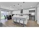 Modern kitchen boasts a center island with seating, sleek appliances, and a connected dining area at 1297 Ventura Cliffs Ave, Henderson, NV 89012