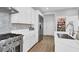 Modern kitchen equipped with stainless steel appliances, white cabinetry, and ample counter space at 1297 Ventura Cliffs Ave, Henderson, NV 89012