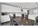 Bright kitchen with white cabinets, stainless steel appliances, and an island with white countertop at 1297 Ventura Cliffs Ave, Henderson, NV 89012