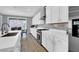 Sleek kitchen with stainless steel appliances, white cabinets, and a center island with seating at 1297 Ventura Cliffs Ave, Henderson, NV 89012