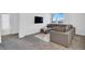 Bright living room with a large sofa, carpet, and a view from the window at 1297 Ventura Cliffs Ave, Henderson, NV 89012