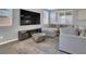 Modern living room featuring an oversized television, comfortable sectional sofa, and stylish décor at 1297 Ventura Cliffs Ave, Henderson, NV 89012