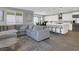 Open-concept living space showcasing a comfortable sectional sofa, kitchen island, and dining area at 1297 Ventura Cliffs Ave, Henderson, NV 89012