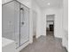 This main bathroom has gray tile floors, glass shower, a separate toilet room, and large vanity at 1297 Ventura Cliffs Ave, Henderson, NV 89012