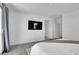 This main bedroom has a television, neutral colored walls and carpet, and access to the bathroom at 1297 Ventura Cliffs Ave, Henderson, NV 89012