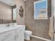 Modern powder room with a decorative accent wall and a sleek vanity at 1297 Ventura Cliffs Ave, Henderson, NV 89012