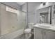 Bathroom featuring shower-tub combo, glass sliding door, and white single sink vanity at 1501 Oscar Ct # 101, Las Vegas, NV 89146